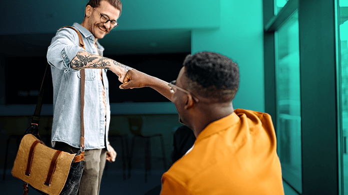 Two men fist bumping