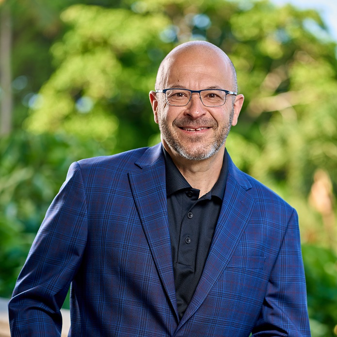 Smiling man in blue plaid suit with glasses