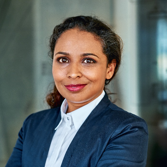 Woman in blue suit smiles