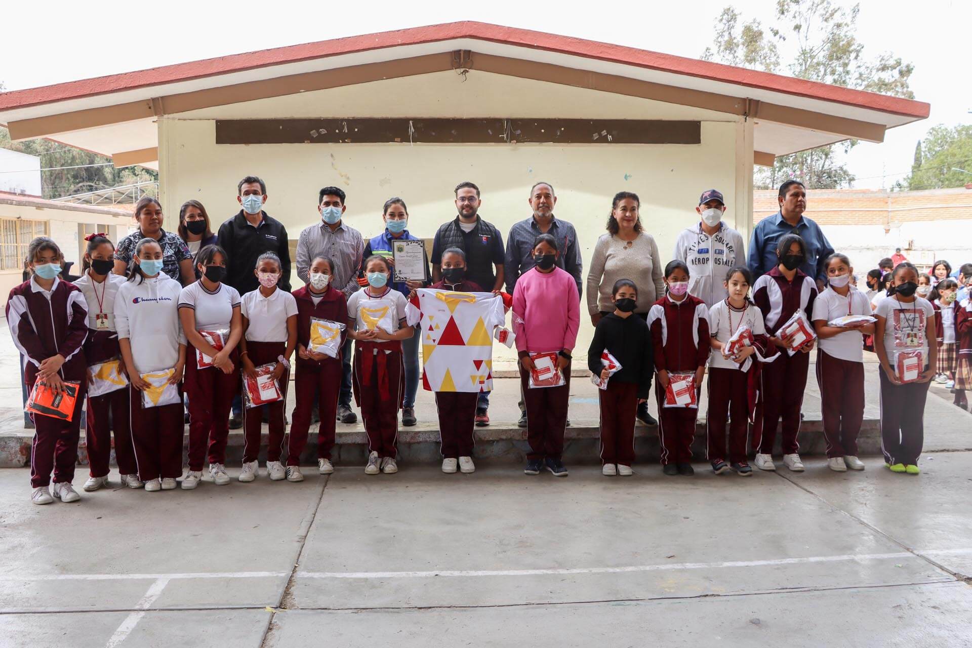 a group of people wearing masks and holding a group of objects