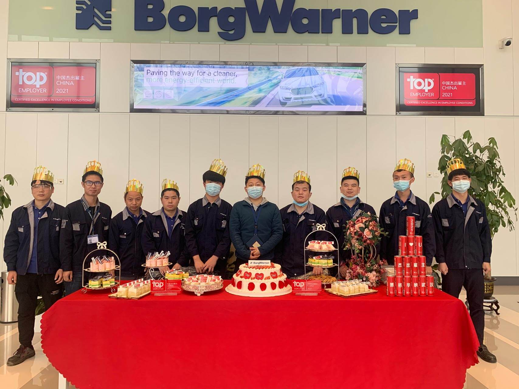 a group of people standing in front of a table with food